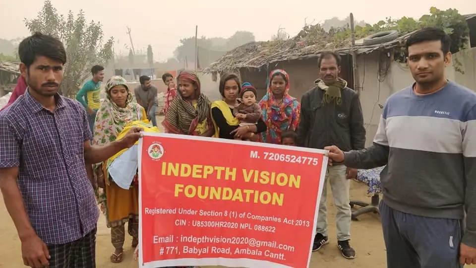 A group of people holding up an indepth vision foundation sign.